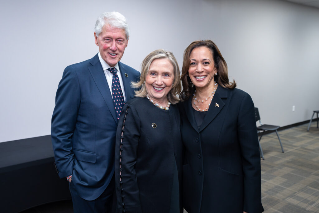 Bill Clinton, Hillary Clinton, and Kamala Harris posing for the camera