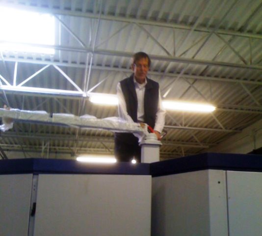 Bob Prokop, author of Civil Candor, at work on top of a machine.