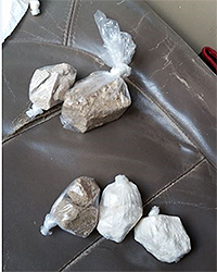Police battle drugs and guns. Seizure of crack cocaine and heroin. Courtesy DEA/Justice Dept.