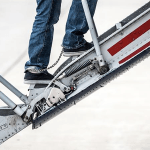 Feet with cuffs walking up jet stairs