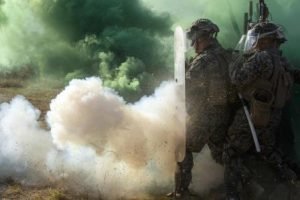 Soldiers in riot gear surrounded by smoke. U.S. Dept. of Defense photo. 