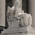 Statue of Contemplation of Justice by James Earle Fraser on the U.S. Supreme Court Building's main steps. Architect of the Capitol.