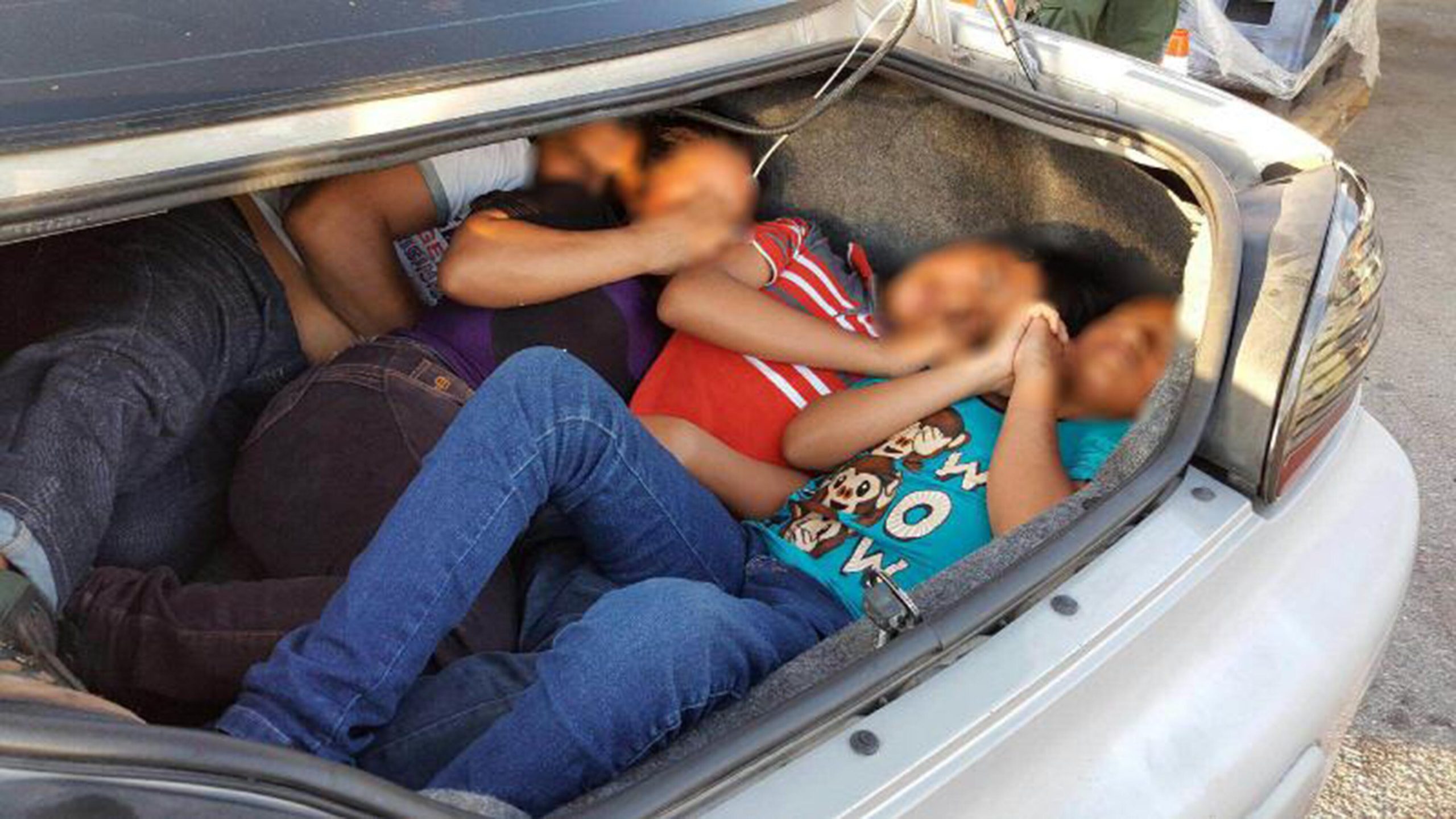 Smuggled illegal immigrants in car trunk. CBP photo.