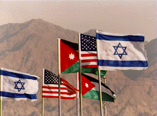 Israeli, Palestinian, and American flags flying. 