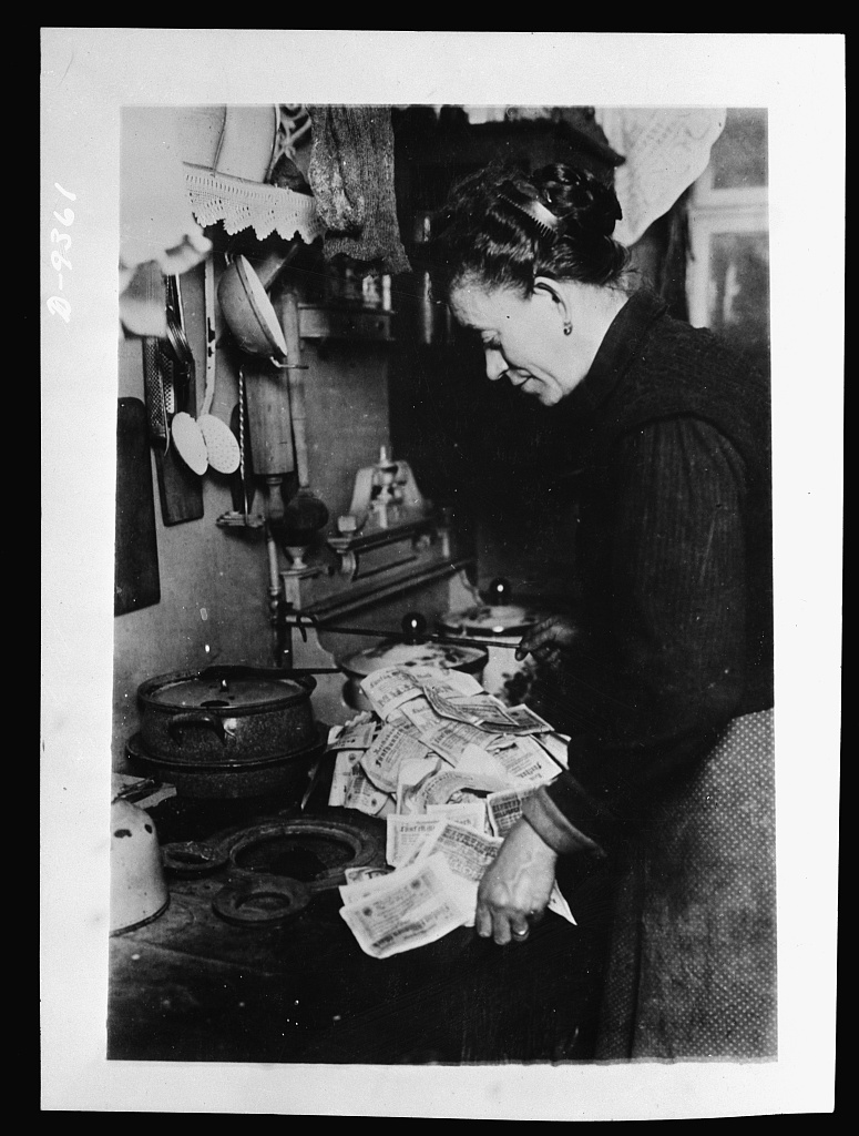 Woman in Germany starting morning fire with worthless marks. Library of Congress.